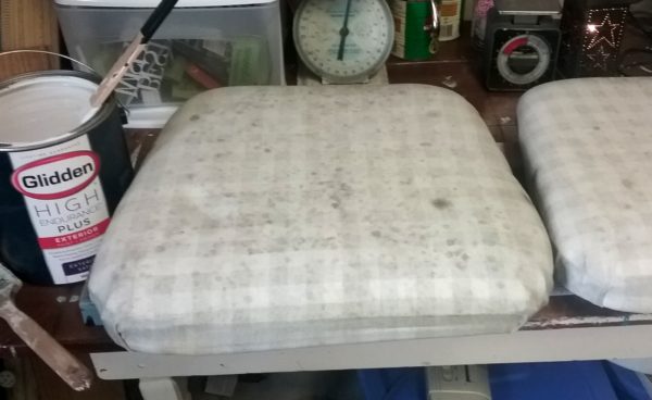 Old faded fabric chair seat cushion