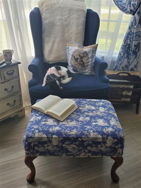 Home library reading nook with blue wingback chair