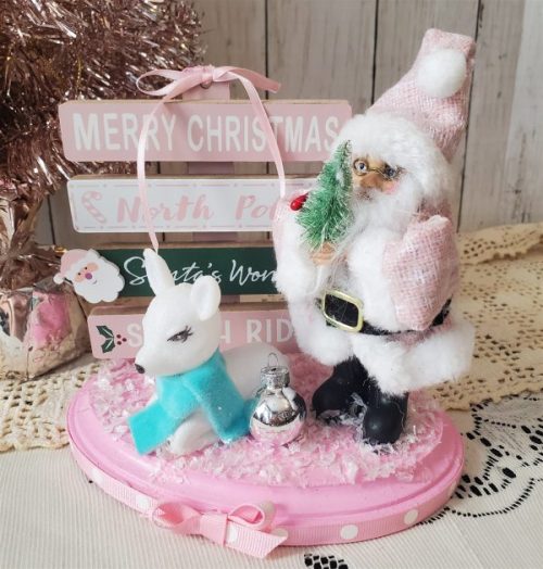 One-of-a-kind pink Santa Christmas diorama with retro reindeer, wooden North Pole sign and faux snow on a pink base BACK
