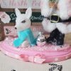 One-of-a-kind pink Santa Christmas diorama with retro reindeer, wooden North Pole sign and faux snow on a pink base