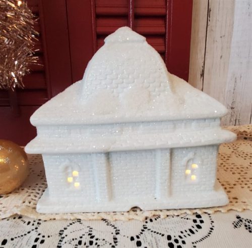 White glittered ceramic Christmas village train station with electric light and three-piece train set back