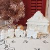 White glittered ceramic Christmas village train station with electric light and three-piece train set