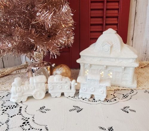 White glittered ceramic Christmas village train station with electric light and three-piece train set