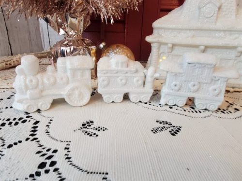 White glittered ceramic Christmas village train station with electric light and three-piece train set