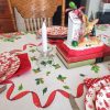 Vintage mid-century holiday table linen displayed on a dining table with classic red and green Christmas print.